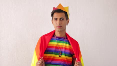 Young-gay-latino-man-in-rainbow-outfit-and-flag-for-LGBTQ-pride-parade
