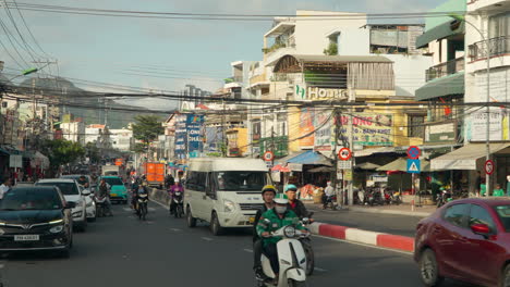 Vietnamese-People-Riding-Motorcycles-and-Drive-Cars-on-Busy-Street-Road-in-Nha-Trang-City,-Central-Vietnam