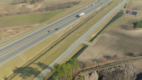 Aerial-tilt-up-shot-of-construction-site-near-highway-of-Poland