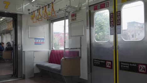 Empty-train-interior-with-red-seats,-daylight,-slight-motion-blur