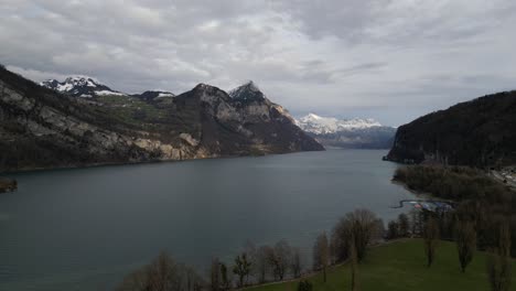 Aerial-slow-pan-above-lake-shoreline-in-Walensee-Switzerland