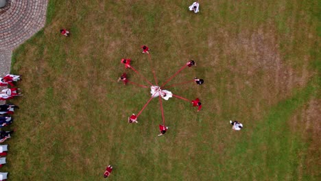 Aerial-overhead-shot-of-a-newly-married-couple-experiencing-a-traditional-event