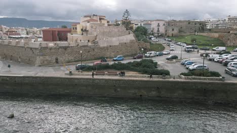 People-walking-along-Firka-Venetian-Fortress,-Chania,-Crete-Island,-Greece