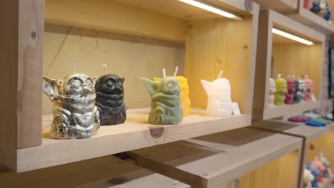 Fantasy-inspired-yoda-character-candles-on-a-wooden-shelf,-La-Candela-Store-Venice
