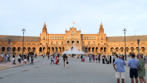 Tourists-observing-pavilion-buildings-in-Plaza-de-España,-Seville