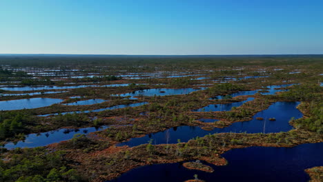 Flat-marsh-wetland-islands-in-a-wide-landscape---aerial-parallax