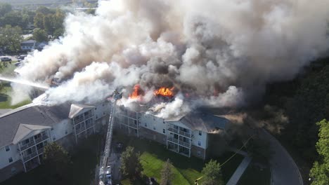 Senior-Living-Apartments-on-fire-with-massive-smoke,-aerial-drone-view