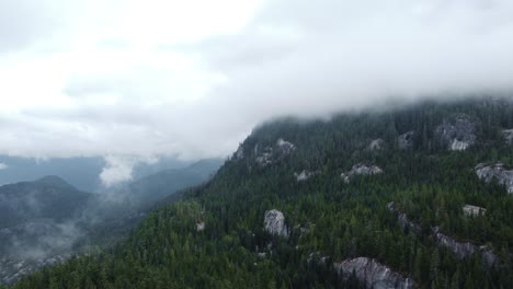 Aerial-footage-over-the-mountains-in-Squamish,-British-Columbia-on-a-cloudy-day