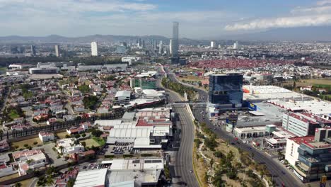 Shopping-center,-traffic-on-highway,-suburb-neighborhood-and-Skyscraper-in-downtown-of-Puebla-City,-Mexico