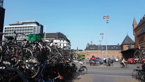 Copenhagen,-Denmark,-Big-Bicycle-Parking-in-Front-of-Central-Train-Station-on-Sunny-Day,-Panorama