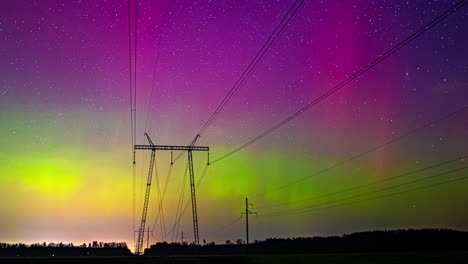 Colorful-aurora-borealis-dancing-over-power-lines-at-twilight,-starry-sky-backdrop,-timelapse