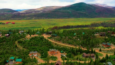 Small-Mountain-Town-with-Houses-Surrounded-by-Lush-Summer-Forests-in-the-Rocky-Mountains