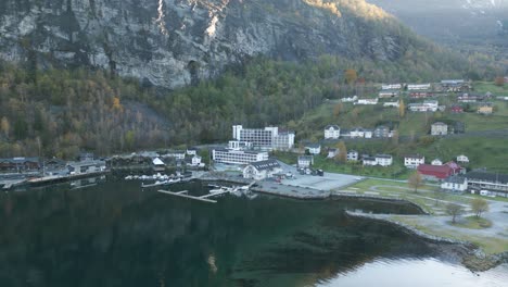 Geiranger-waterfront-with-buildings-and-moored-boats,-norway,-aerial-view