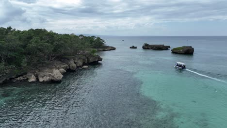 Tourists-on-touristic-boat-navigating-towards-Playa-Caleton-beach-in-Dominican-Republic