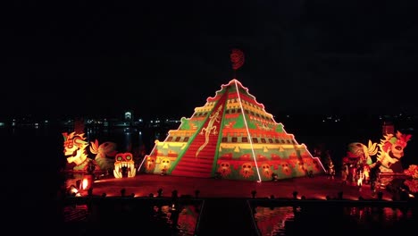 Aerial-wide-shot-of-orange-lights-at-night-and-dancing-group-in-Mexico