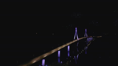 Nighttime-view-of-Replot-Bridge-with-vibrant-fireworks-display-in-the-sky,-lights-reflecting-on-water