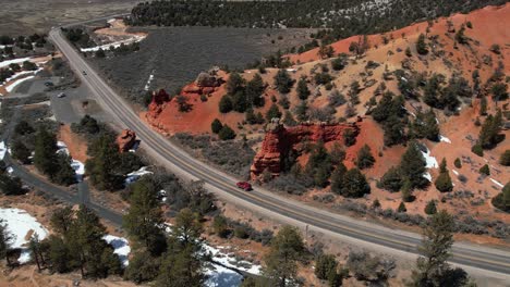 Aerial-View-of-Red-SUV-Vehicle-Moving-on-Scenic-State-Route-in-Countryside-of-Arizona-USA-on-Sunny-Winter-Day