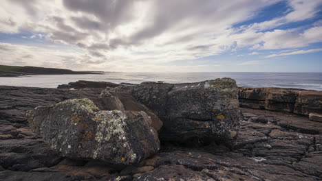 Panorama-motion-timelapse-of-rugged-rocky-coastline-on-sunny-cloudy-day-with-Classiebawn-castle-in-distance-in-Mullaghmore-Head-in-county-Sligo-on-the-Wild-Atlantic-Way-in-Ireland