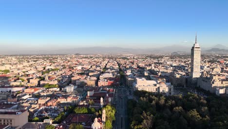 Drone-shot-of-latino-tower-and-volcanoes-in-mexico-city