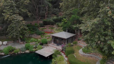 Fly-through-the-trees-over-covered-lush-ponds-and-botanical-gardens-near-Malibu-horse-stables