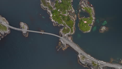 Aerial-view-over-cars-driving-along-the-Atlantic-Bridge-Road-in-Norway-on-a-cloudy-day