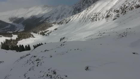 A-high-flying,-4K-drone-shot-over-the-extreme-downhill-terrain-of-the-"East-Wall"-at-Arapahoe-Basin-Ski-Resort,-located-in-the-Rocky-Mountains-of-Colorado,-during-the-middle-of-the-winter-season