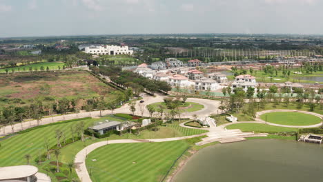 Aerial-Shot-of-Car-Driving-Down-Boulevard-at-Luxurious-Gold-Resort-in-Thailand