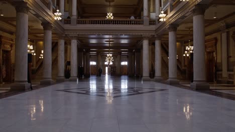 Inside-Indiana-state-capitol-building-in-Indianapolis,-Indiana-with-hallway-shot-tilting-down