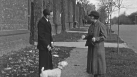 Una-Pareja-Discute-En-La-Acera-Durante-Un-Paseo-De-Perros-En-La-Ciudad-De-Nueva-York-En-1930