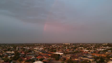 Aerial-view-of-northern-Perth-suburbs-with-a-rainbow-at-sunset,-Western-Australia