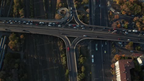 Busy-traffic-on-overpass-in-bucharest-during-golden-hour,-dynamic-city-life,-aerial-view