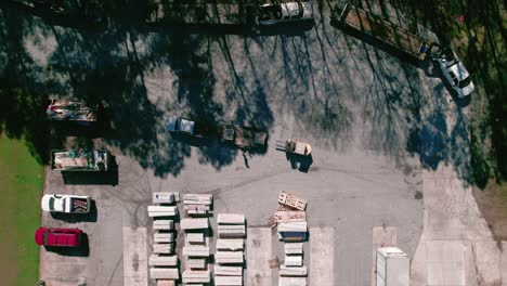 Forklift-worker-placing-cement-vinyl-sidings-on-flatbed-hotshot-pickup-truck