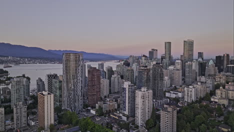 Vancouver-BC-Canada-Aerial-v65-cinematic-drone-flyover-West-End-residential-neighborhood-capturing-downtown-cityscape-with-towering-high-rise-buildings-at-dusk---Shot-with-Mavic-3-Pro-Cine---July-2023