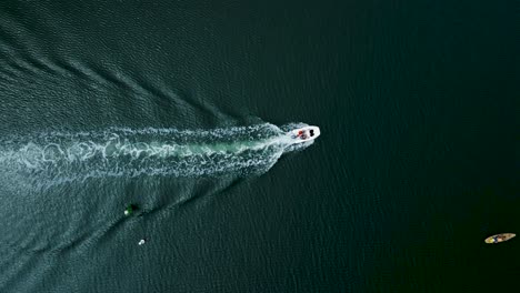 Aerial-drone-footage-tracks-a-boat-sailing-in-the-ocean-in-California-on-a-sunny-day