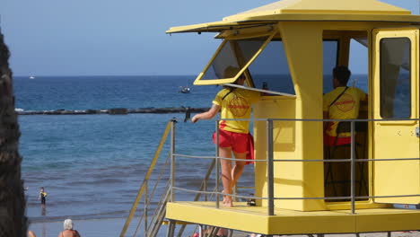 A-yellow-lifeguard-tower-stands-vigil-on-a-sandy-beach