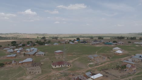 Forward-rising-aerial-shot-of-African-countryside-on-sunny-and-cloudy-day