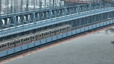 High-speed-urban-train-traveling-under-a-bridge