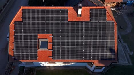 Bird's-Eye-View-Over-Photovoltaic-System-On-The-Tiled-Roof-Of-A-House---Drone-Shot