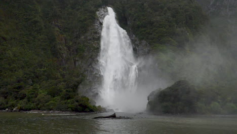 Slow-Motion-static-footage-of-a-full-waterfall-in-Milford-Sound---Piopiotahi,-New-Zealand