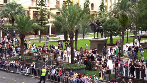People-in-Brisbane-lined-up-along-Adelaide-Street,-patiently-waiting-for-the-commencement-of-traditional-Anzac-Day-parade