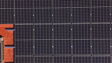 Top-Down-View-Of-Solar-Photovoltaic-Panel-System-On-Roof---Drone-Shot