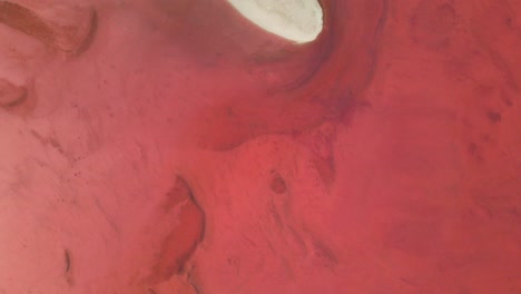Top-down-view-of-a-red-and-pink-salt-pan
