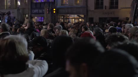 Winter-Street-Scene-with-Crowd-Watching,-Filming-Camera-in-Background