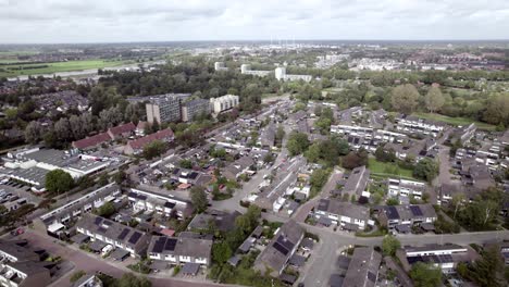 Wide-aerial-view-of-shopping-mal-car-parking-lot-in-Dutch-residential-neighbourhood