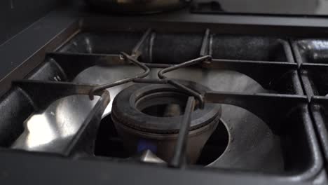 Turning-On-Gas-Stove-Fire-And-Putting-Pan-On-It-To-Heat