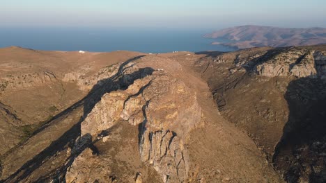 Steep-rocky-cliff,-ocean-in-the-background,-on-Kythnos-Island,-Greece