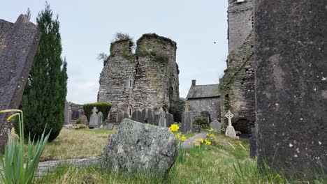 Old-Irish-graveyard-with-castle-and-headstones-in-spring