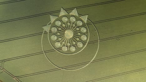 High-angle-aerial-over-crop-circle-in-green-farm-land,-Owslebury,-Hampshire