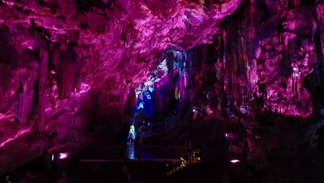 Tourists-in-a-famous-cave-with-purple-lights