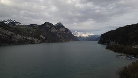 Aerial-establishing-pullback-above-Lake-Walen-in-Walensee-Switzerland-on-overcast-day